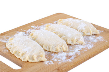Raw dumpling with cheese. Preparation dumplings on a wooden board