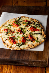 Pizza. Classic traditional Italian entrée favorite. New York Style Pizza with marinara sauce and topped with mozzarella cheese, meats and fresh vegetables. Baked in wood burning oven
