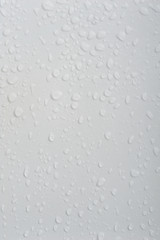 Beautiful water drops at a clean wall in difference sizes from small ones to big ones nice and perfect background for many occasions