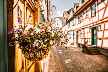old street in idstein germany, with floral arrangement, half-timbered houses during the day