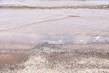 View of the sandy beach and the sea. Winter season. Cloudy, calm weather.