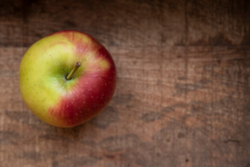 Garden green apples on a background of a wooden textured board.