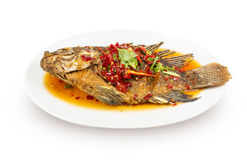 Whole Fried Fish Topped With Sweet Chili three flavors in a white bowl, Thai food.