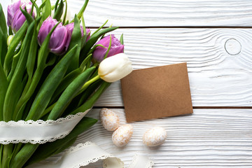 Easter eggs and spring flowers on a wooden background.Image