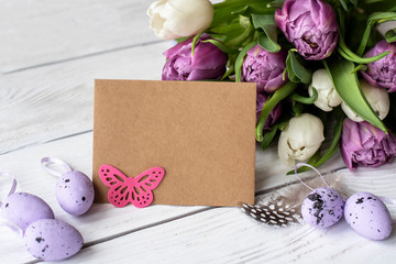 Easter eggs and spring flowers on a wooden background.Image