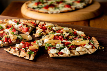 Pizza. Classic traditional Italian entrée favorite. New York Style Pizza with marinara sauce and topped with mozzarella cheese, meats and fresh vegetables. Baked in wood burning oven