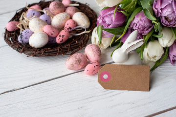 Easter eggs and spring flowers on a wooden background.Image