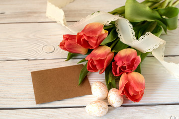 Easter eggs and spring flowers on a wooden background.Image