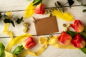 Easter eggs and spring flowers on a wooden background.Image