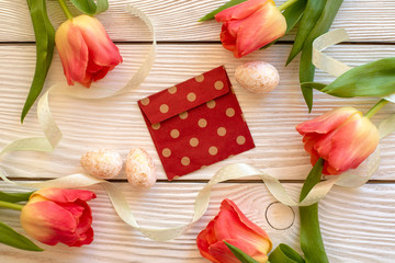 Easter eggs and spring flowers on a wooden background.Image