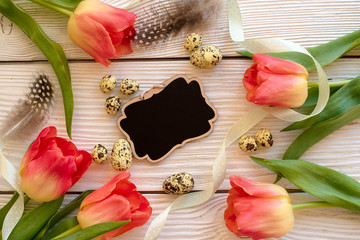 Easter eggs and spring flowers on a wooden background.Image