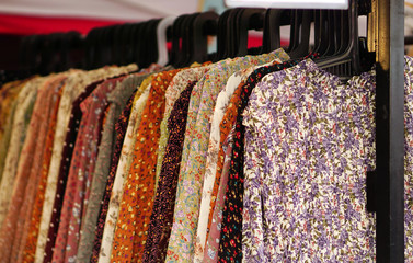  Closeup view of Indian woman fancy and fashion dress Hung on hangers in display of a retail shop  ...