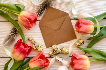 Easter eggs and spring flowers on a wooden background.Image