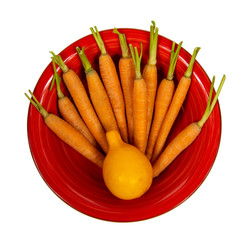 Orange Lemon and small carrots on a red plate isolated on a white background. Top view. Flat lay