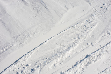 Snow close-up. Ski slope with traces of skis
