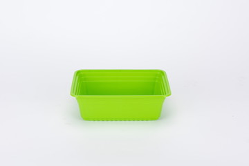 The green disposable tableware is isolated in the white background,