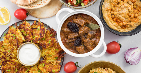 Israeli cuisine: esik fleisch - beef stew with damson plums and spices, hummus,  potato latkes,...