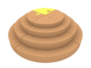 Wooden puzzle construction with yellow puzzle piece on top