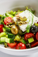 Greek salad in white bowl