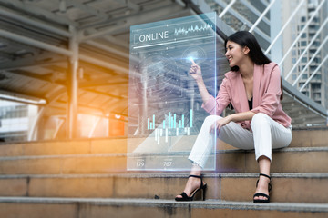 Strategy and digital 5G hologram Concept.Portrait of young Asian woman happy and looking on the digital hologram to expand her business to around the world.businesswoman analyzing growth graph chart.