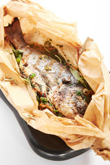 Baked dorado fish in parchment
