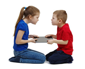 Two kids boy and girl fighting for tablet .