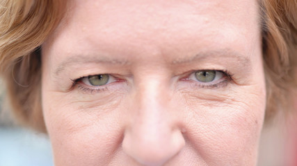 The Close up of Blinking Eyes of Old Woman