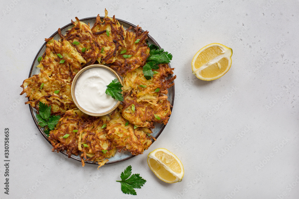 Poster latkes or drank, or deruny - are panfried pancakes made from grated potato, onion, egg. served with 