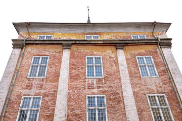 Obraz premium Wall of a residential building with closed windows and old stucco House Exterior Details in Estonia