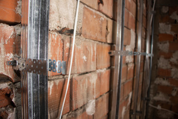 Fototapeta na wymiar putting plasterboard on the wall preparation for insulation