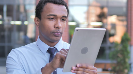Fototapeta premium African Businessman Using Tablet Outdoor