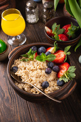Homemade oatmeal granola or muesli with fresh berries for healthy easter morning breakfast, selective focus. Healthy food background.