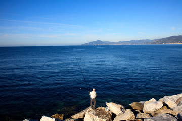 Fototapeta na wymiar Sestri Levante (GE), Italy - June 01, 2017: Fisherman in Sestri Levante, Genova, Liguria, Italy