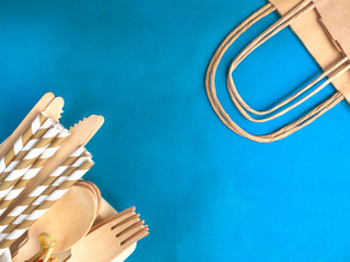 Disposable wooden cutlery on blue background