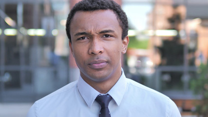 Obraz premium Portrait of Upset Sad African Businessman