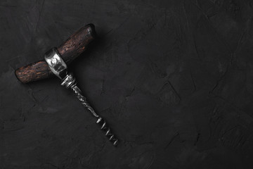 Beautiful vintage corkscrew on black background. empty space