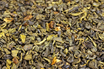 Green tea with flowers and fruits top view close up, background, texture