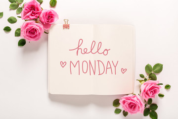 Hello Monday message with roses and leaves top view flat lay