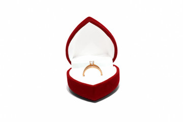 Jewelry red box with beautiful gold ring on white background. Ring in a velvet box isolate. Wedding proposal. Horizontal photo