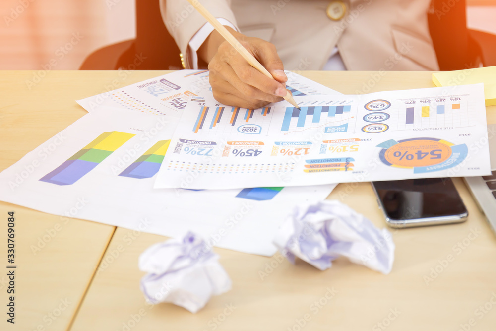 Poster close-up image of business executive analyzing diagram in financial report with sales data