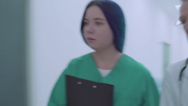 Doctor and nurse rushing to emergency room, running in hospital, first aid