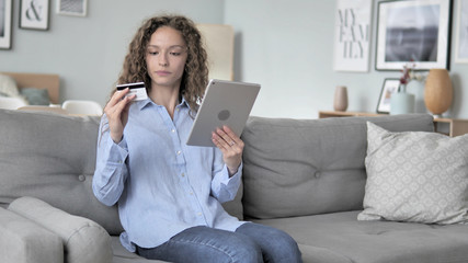 Online Shopping on Tablet by Curly Hair Woman Sitting on Couch