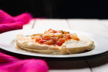 Mexican quesadilla with corn tortilla and piquant sauce also called 
