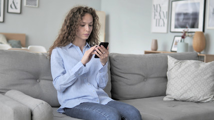 Excited Curly Hair Woman Successfully Shopping Online on Smartphone