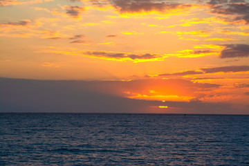 Naklejka na ściany i meble Dramatic sky over the sea at sunset
