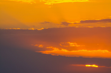 Dark clouds and orange sky at sunset