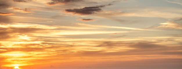 Fototapeta na wymiar Orange sky with clouds at sunset in Sardinia