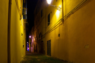 Narrow alley in old town Alghero by night