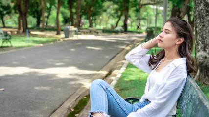  Beautiful Asian women with long hair wearing a white shirt. White bug hat, jeans showing emotions In the nature park-09.jpg, Asian beautiful woman with yellow skin, long black hair, wearing a white s