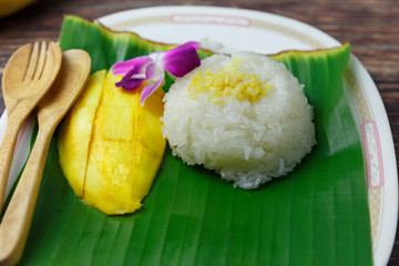 Mango sticky rice on a plate with serving